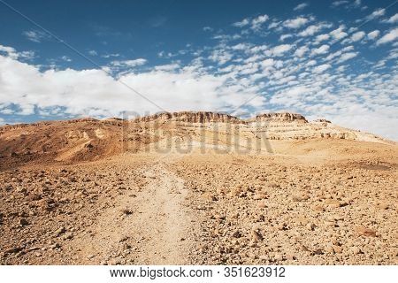 Negev Desert In Israel. Mitzpe Ramon Crater Landscape. Sandy Rocky Walking Trail. High Temperature D