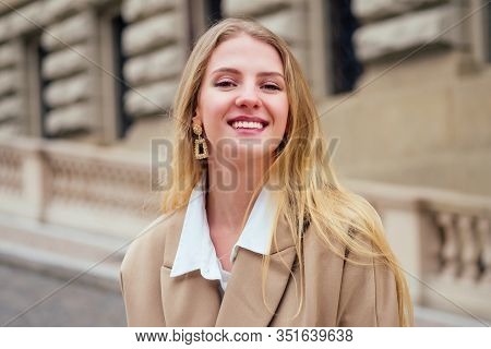 Outdoor Portrait Of Young Beautiful Fashionable Woman Wearing Trendy Jacket With Small Shoulder Bag,