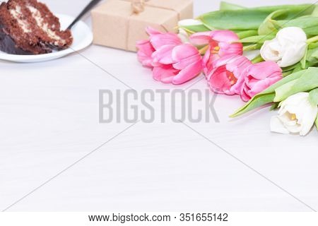 Bouquet Of Pink Tulips, Chocolate Cake. Pressent Box On White Wooden Background. Copy Space, Close U