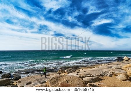 A Man Athlete Runs Along The Seashore On A Sunny Day. Trail Running. Mangystau Peninsula. Kazakhstan