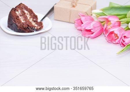 Bouquet Of Pink Tulips, Chocolate Cake. Pressent Box On White Wooden Background. Copy Space, Close U