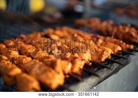 Paneer Fish Chicken Tikka Roasting On An Open Hearth With Glowing Coals And Smoke Coming Out