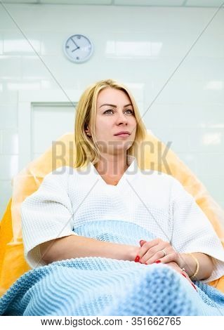 Woman Sitting In White Bathrobe At Beauty Salon. Planning Beauty Treatment. Aethetic Medicine Concep