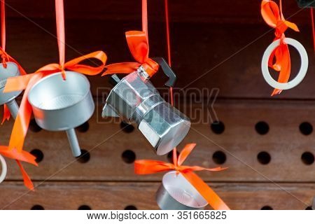 Christmas Decoration In Cafe, Traditional Italian Coffeemaker Macchinettas Hanging On Red Ribbons Ou
