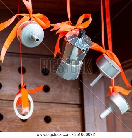 Christmas Decoration In Cafe, Traditional Italian Coffeemaker Macchinettas Hanging On Red Ribbons Ou