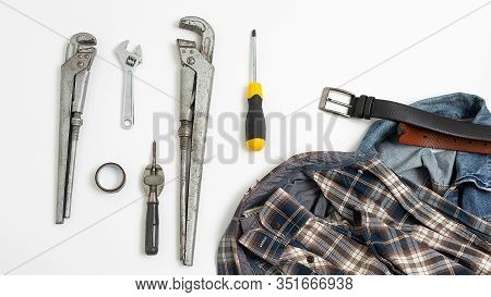 Set Of Metal Tools Near Checkered Shirt, Jeans, Leather Belt Top View. Mens Job Flat Lay Isolated On