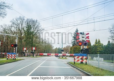 Zeist, Netherlands - January 04, 2020. Railroad Crossing With Red Lights