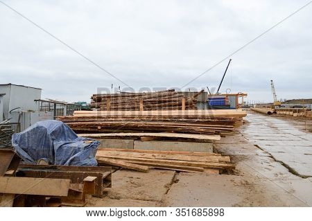 Lots Of Long Wooden Natural Planed Boards And Sticks At A Sawmill. The Background. Texture. Concept: