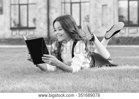 Always Visit The Library. Happy Bookworm. Small Child Read Library Book On Green Grass. Adorable Lit