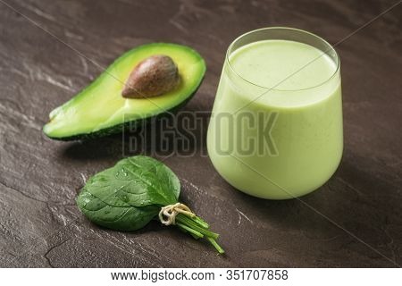 Bunch Of Spinach Leaves, Avocado And Smoothies On A Stone Background. Fitness Product. Dietary Sport