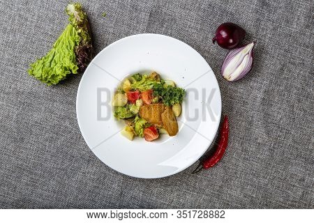 Salad With Black Sea Rapan Meat, Dressed With Honey Sauce. With Rye Crackers. On A Gray Canvas Cloth