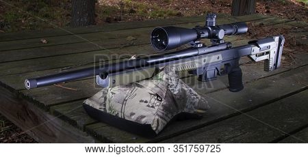 Green Stocked Bolt Action Rifle On A Sandbag On A Shooting Rest