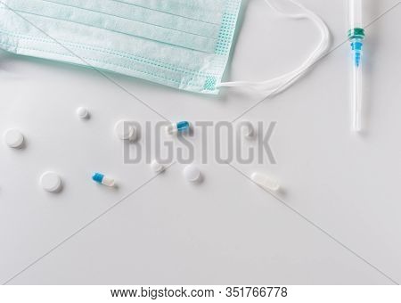 Pharmaceutical Medicine Pills, Tablets, Surgical Protective Mask And Plastic Syringe Overlight  Back
