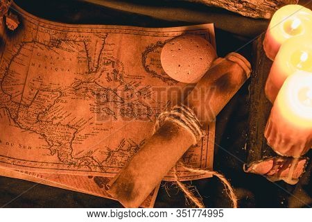 Old Plans Next To Other Elements In The Light Of Candles In Rustic Wood