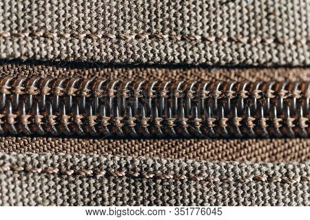 Vintage Zipper On Color Haki Cloth. Closeup. Macro
