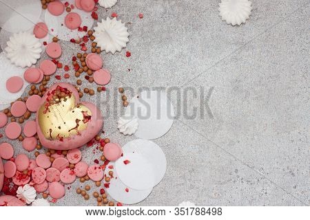 Pink Hearts From Tempered Chocolate With Chocolate Drops, Meringues And Dried Berries On Grey Backgr