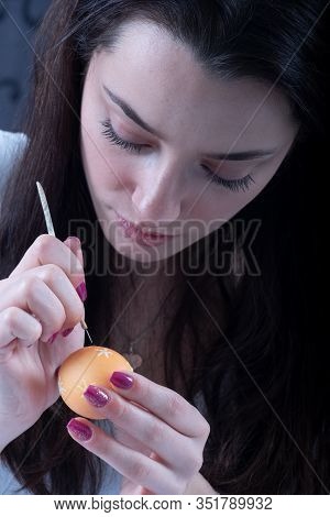 Young Beautiful Sexy German Woman With Dark Hair Paints A Yellow Easter Egg According To Sorbian Tra