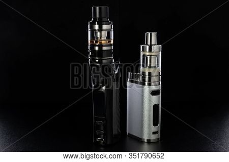 Electronic Cigarettes Or Vaping Devices On Black Background