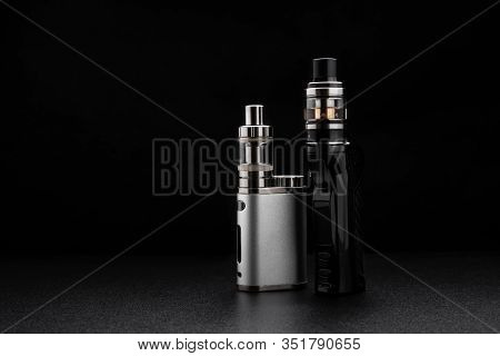 Electronic Cigarettes Or Vaping Devices On Black Background