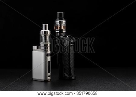 Electronic Cigarettes Or Vaping Devices On Black Background