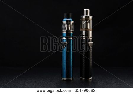 Electronic Cigarettes Or Vaping Devices On Black Background