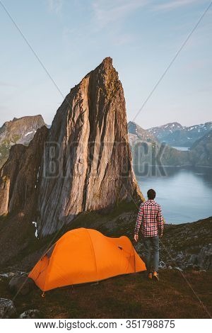 Camping Tent And Man Solo Traveler Hiking In Norway Sustainable Travel Adventure Healthy Lifestyle A