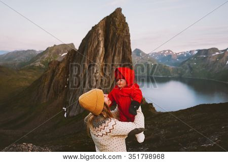 Mother Holding Up Baby Family Vacation Travel In Mountains Norway Hiking Together Active Healthy Lif