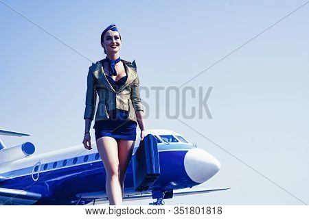 Stewardess. Journey And Jet Trip. Woman And Commercial Plane. Portrait Of Charming Stewardess Wearin