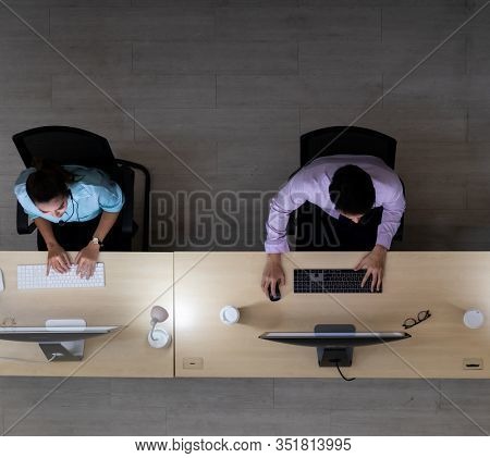 Late Night Environment, Top view of call centre operator team with headsets working in a call centre customer service and technical support. Using for 24 Hr. Call center Concept.