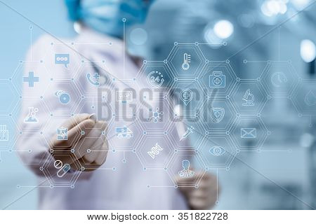 The Concept Of Treatment With Pills.doctor Shows A Medicine Pill On A Blurred Background.