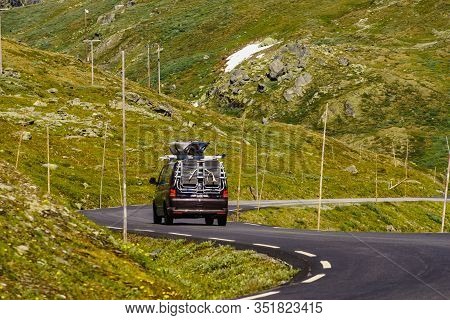 Sognefjellet, Norway - July 7, 2018: Camper Van With With Recreational Equipment Conoes On Roof Driv