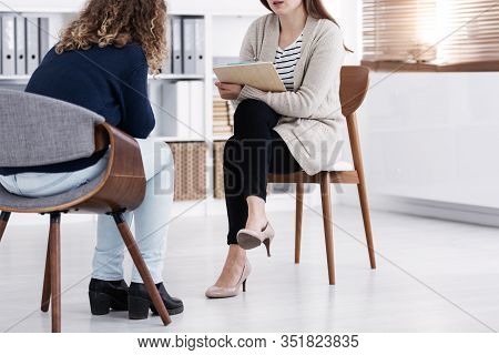 Professional Counselor And Woman Suffering From Depression During Therapy