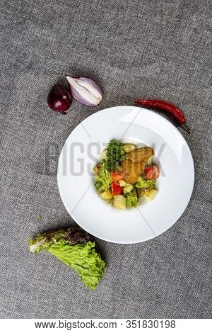 Salad With Black Sea Rapan Meat, Dressed With Honey Sauce. With Rye Crackers. On A Gray Canvas Cloth