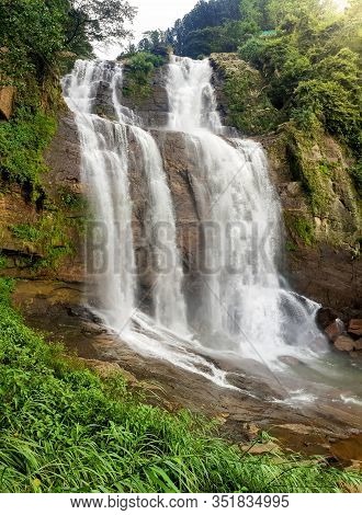 Beautiful Photo Of Big Waterfall In The Jungle Forest At Sunset