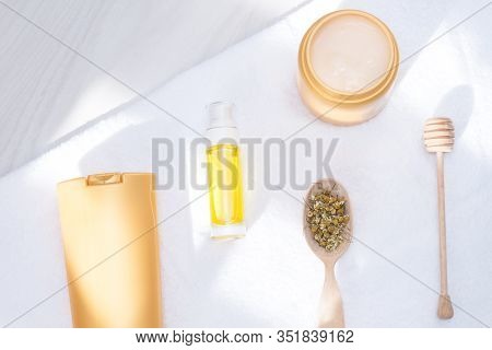 Body And Hair Care Prodacts, Toiletries With Towel, Sunlight On White Background. Care And Clean Con