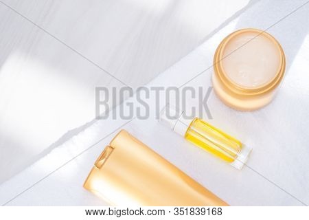 Body And Hair Care Prodacts, Toiletries With Towel, Sunlight On White Background. Care And Clean Con