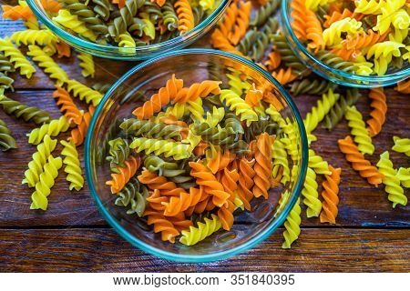Composition Of Raw Pasta Uncooked Tricolore Fusilli, Pasta Twist Shape. Close Up And Selective Focus