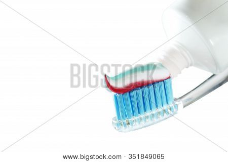 Toothbrush And Toothpaste On Blurred Background. Care For The Oral Cavity And Teet