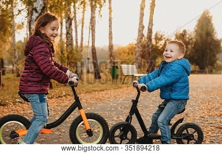 Close Up Photo Of Two Caucasian Brothers That Stopped Face To Face Their Bikes And Are Smiling Joyfu