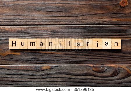 Humanitarian Word Written On Wood Block. Humanitarian Text On Table, Concept