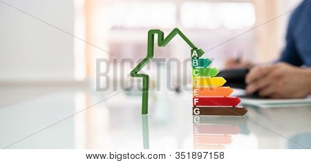 Cropped Image Of Businessman Calculating Energy Efficiency Rate In Office