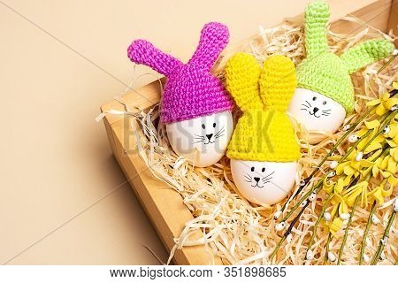 Easter Background. Easter Decorative Eggs With Painted Cheerful Faces And Crocheted Ears In The Form