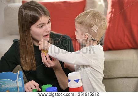A Boy With Cochlear Implants Playing With His Mother
