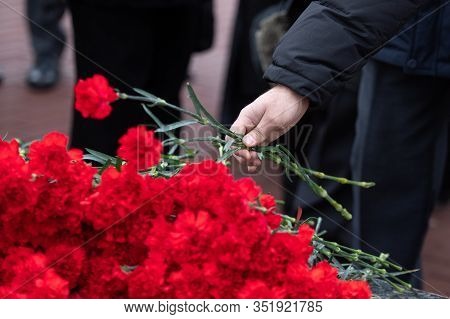Red Carnations Are Laid On The Marble Memorial In Honor Of Those Killed In The War