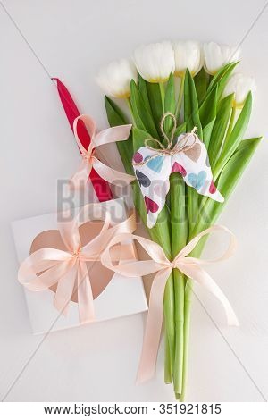 White Tulips, Gift Box With Pink Candle Ribbon Bow On Light Background Flat Lay. Text Place 8 March 