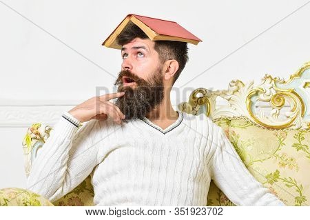 Lose Mind Concept. Macho Sits With Open Book On Head, Like Roof. Man On Crazy Face With Beard And Mu