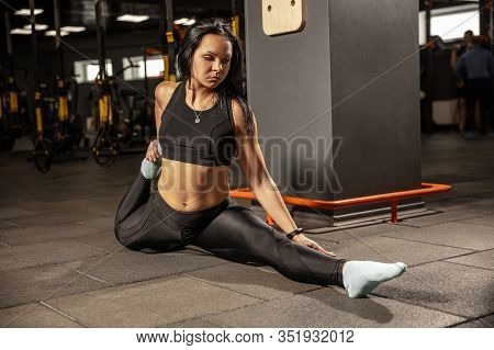 Balance. Young Muscular Caucasian Woman Practicing In Gym With Equipment. Athletic Female Model Doin