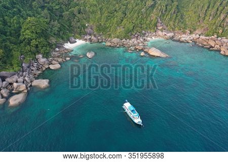 Tropical island and scuba diving liveaboard boat. Aerial photo	