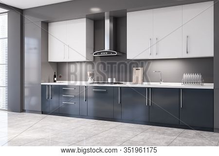 Corner Of Stylish Kitchen With Grey Walls, Tiled Floor, Dark Blue Countertops With Built In Applianc