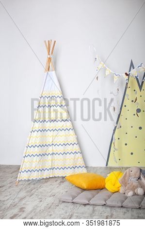 Interior Of Modern Children Room With Yellow Teepee. Children Wigwam Home. Interior Of Stylish Child